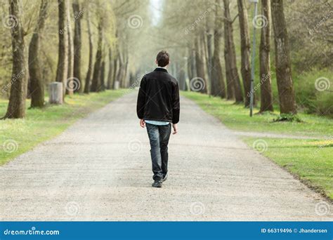 Teenage Boy Walking Down A Rural Road Stock Photo Image 66319496