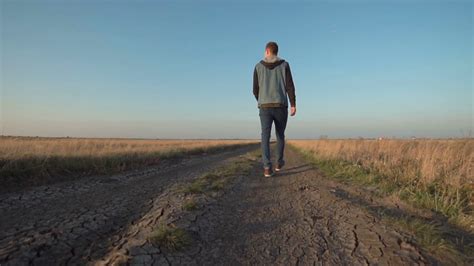 Young Man Walking Down Rural Road In Unique Stock Footage Sbv 318691159