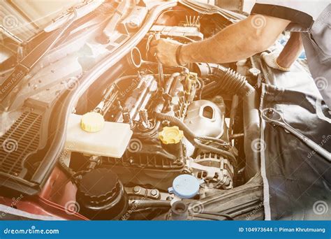 Mechanic Working And Repair Car In Car Service Centre Stock Photo
