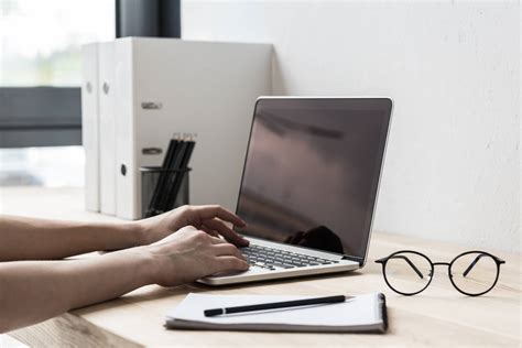 cropped-shot-of-woman-typing-on-computer-at-workpl-8PX2BSV ...