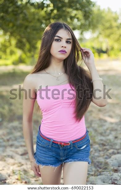Sexy Girl In Denim Shorts And A Vest