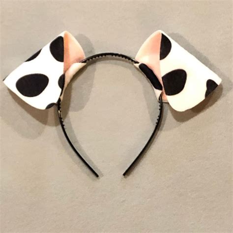 A Minnie Mouse Ears Headband With Black And White Polka Dots