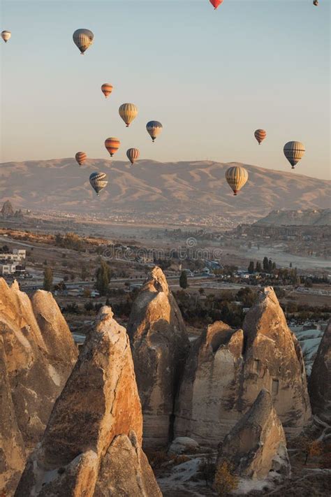 Cappadocia View Of Goreme Town With Caves And Hot Air Balloons In