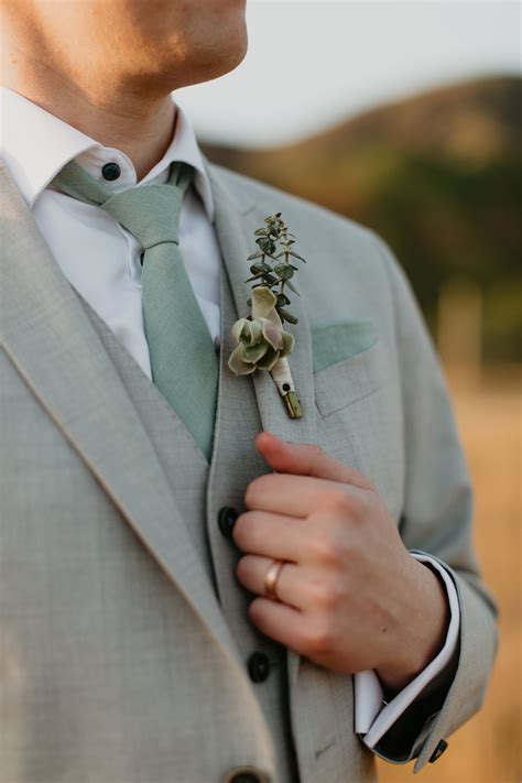 Groom With Grey Suit Green Tie And Succulent Boutonniere And Rose Gold