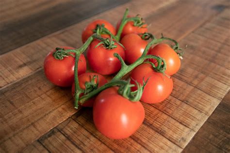 Free Stock Photo Of Handful Of Small Tomatoes On Wooden Surface