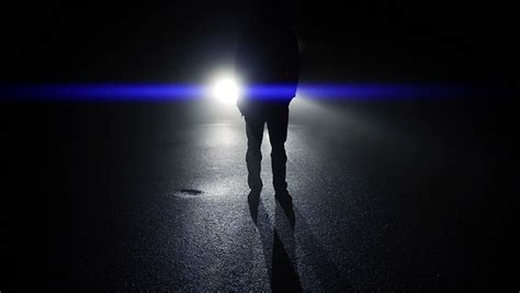 Foot Steps Of Man Walking At Night Car Light Beams