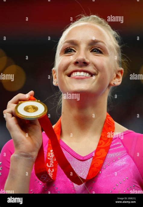 Nastia Liukin Of The Us Holds Her Gold Medal On The Podium After Winning The Womens