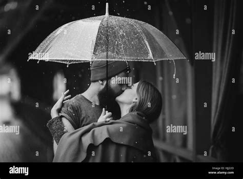 Guy And The Girl Kissing Under An Umbrella Stock Photo Alamy