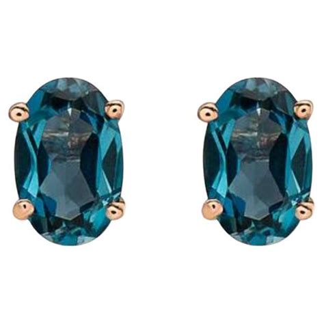 Birthstone Earrings Featuring Deep Sea Blue Topaz Nude Diamonds Set In
