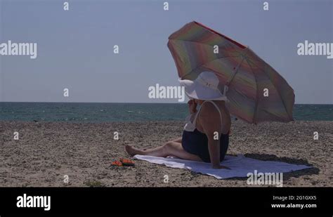 Overweight Woman Sunbathing On The Beach Stock Video Footage Alamy