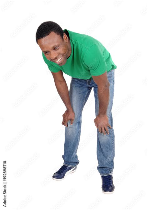 Happy African Man In Jeans Bending Down Stock Photo Adobe Stock