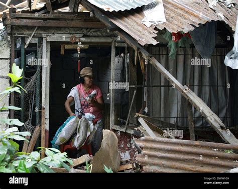 A Filipino Woman Gathers Her Personal Belongings From Her Destroyed