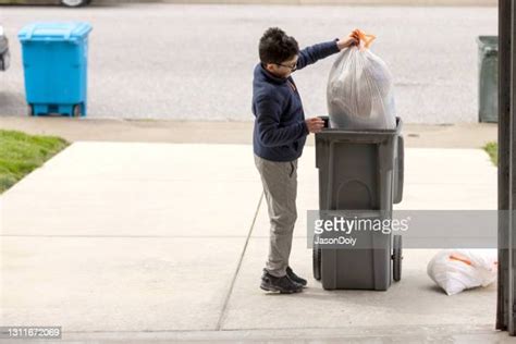 Child Taking Out Trash Photos And Premium High Res Pictures Getty Images