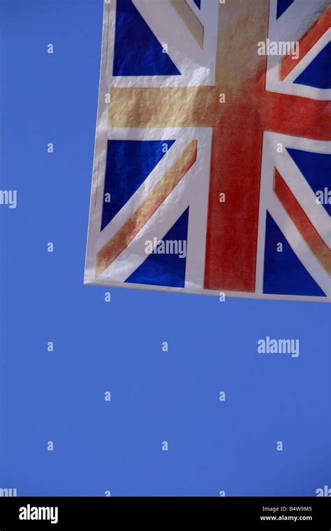 Old Faded Union Jack Flag Flying In Wind In Sun Stock Photo Alamy