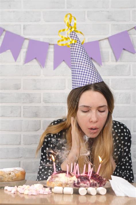 The Girl Blows Out The Candles On The Birthday Cake Stock Image