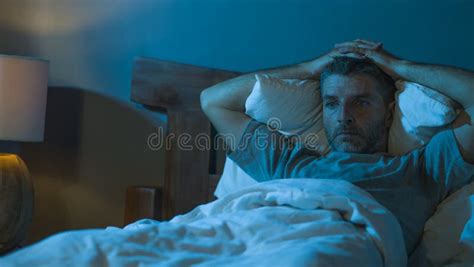 Dramatic Portrait In The Dark Of Attractive Depressed And Worried Man