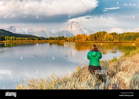 Young Woman Looking Over Autumn Landscape Mount Moran Reflected In