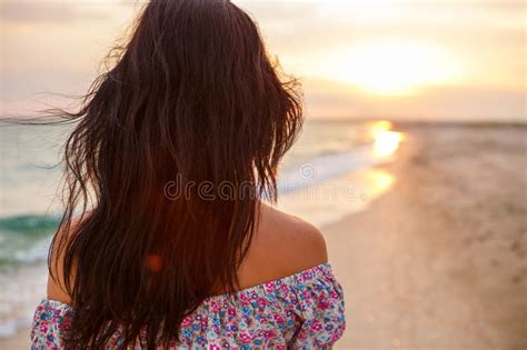 Young Woman Walk On An Empty Wild Beach Towards Celestial Beams Of