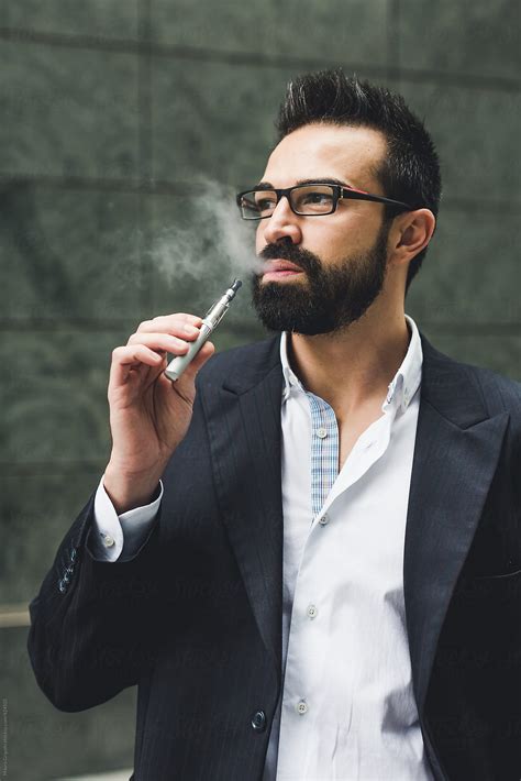 Businessman Smoking E Cigarette By Stocksy Contributor Mauro Grigollo Stocksy