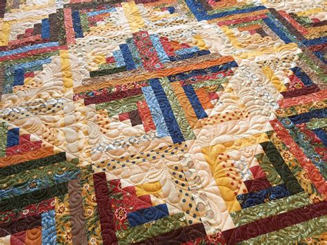 Traditionally, log cabin quilt blocks are designed with a light half and a dark half, with the division sunshine and shadows log cabin quilt layout. Carrie On The Prairie: Barb's Log Cabin quilt