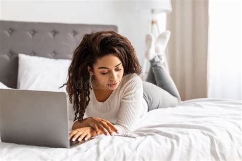 Happy Black Woman Lying In Bed Reading Text Message Stock Image Image