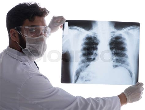 Young Doctor Looking At X Ray Images Isolated On White Stock Image