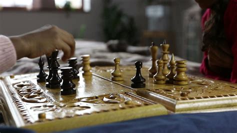 Free fire is an online battle royale game. Playing a game of Chess using an old board - Free Stock Video
