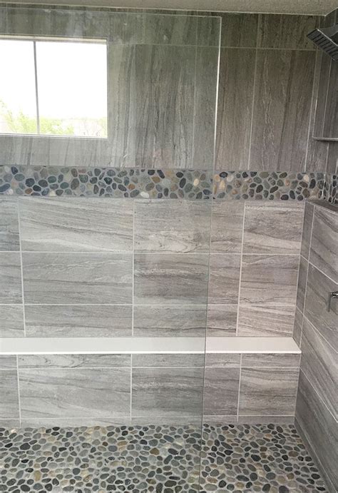 And the sleek, smoky, gray stone slabs alongside the irregular surfaces of the rectangular, moroccan zellige wall tiles (no. Gray stone look large format wall tile with pebble mosaic ...
