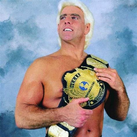 A Man With White Hair Holding A Wrestling Belt