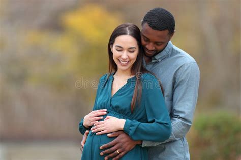 Happy Interracial Couple Looking At Pregnant Belly Stock Photo Image Of Africanamerican