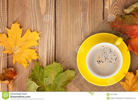 Autumn Leaves And Coffee Cup Over Wood Background Stock