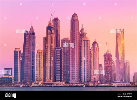 Modern Buildings With Gold Reflection Of Sunset On Dubai Marina Bay