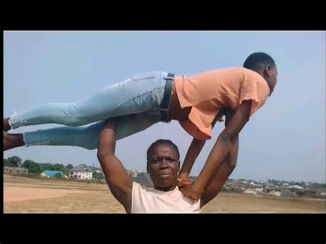 Strong And Fit African Girl Overhead Lift And Carry Also Carry Boy