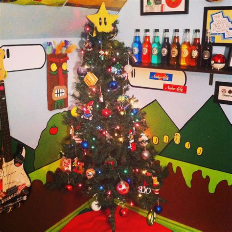 a decorated christmas tree in front of a wall with pictures and other