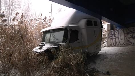 Tractor Trailer Overturns Causing Front Cab To Fall Off Overpass On