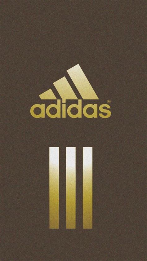 The Adidas Logo Is Shown In Gold And Black On A Brown Background With