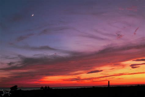 Sunset With Crescent Moon Over The Water Photograph By Danielle Hepler