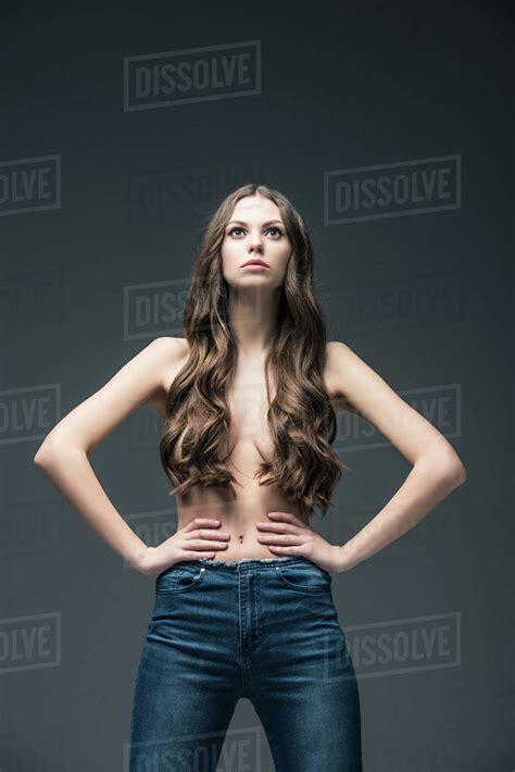 Attractive Half Naked Girl With Long Hair Posing In Jeans Isolated On