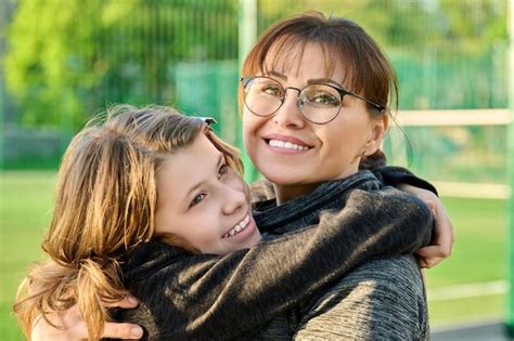 Premium Photo Portrait Of Happy Mom And Preteen Daughter Hugging Together Outdoor