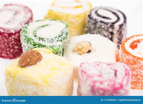 Close Up View Of Assorted Delicious Turkish Delight In Coconut Flakes Isolated On White Stock