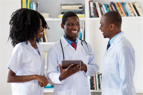 African American Doctors And Nurse Talking About Patient Stock Photo