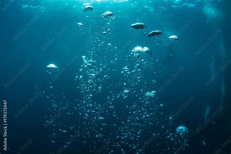 Underwater Shot Of Blue Ocean Water Air Bubbles Closeup Sunbeams On