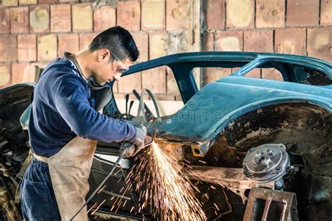 Young Man Mechanical Worker Repairing An Old Vintage Car Stock Image