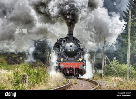 Train Driving In A Bend Steam Engine Smoking Heavily Stock Photo Alamy