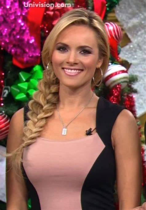 A Woman With Braids On The Set Of Television Show Christmas Special In Front Of A Decorated Tree
