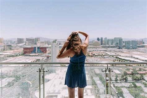 A Young Woman Standing On A Balcony In The Morning Overlooking The Las Vegas Strip By