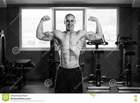 Muscular Man Flexing Muscles In Gym Stock Photo Image Of Lifestyle