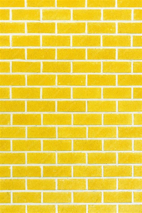 Premium Photo Yellow Brick Wall Background