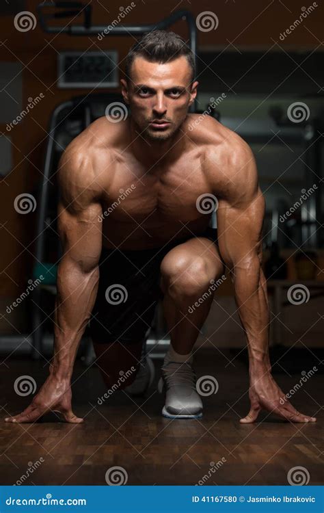 Muscular Man Kneeling On The Floor Shirtless With Japanese Sword Stock