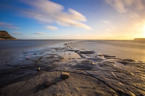 图片素材 海滩 景观 滨 砂 岩 海洋 地平线 云 天空 日出 日落 阳光 早上 支撑 黎明 悬崖 黄昏